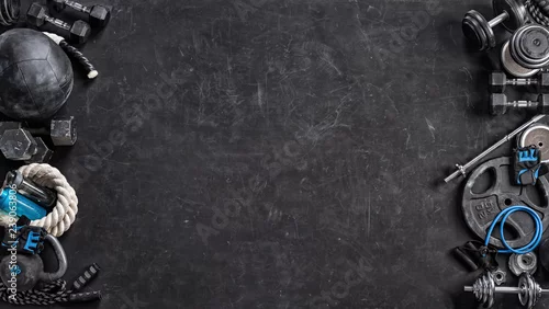 Obraz Sports equipment on a black background. Top view. Motivation