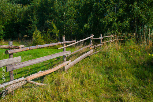 Wooden fence on meadow
