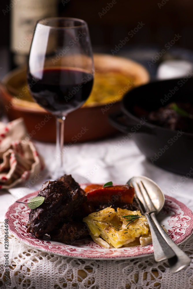 Beef cheeks in red wine with carrots and potato gratin. Beef cheeks in red wine with carrots and potato gratin.