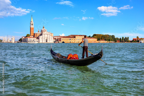 A gondolier in Venice going to San Giorgio Maggiore island, Ital