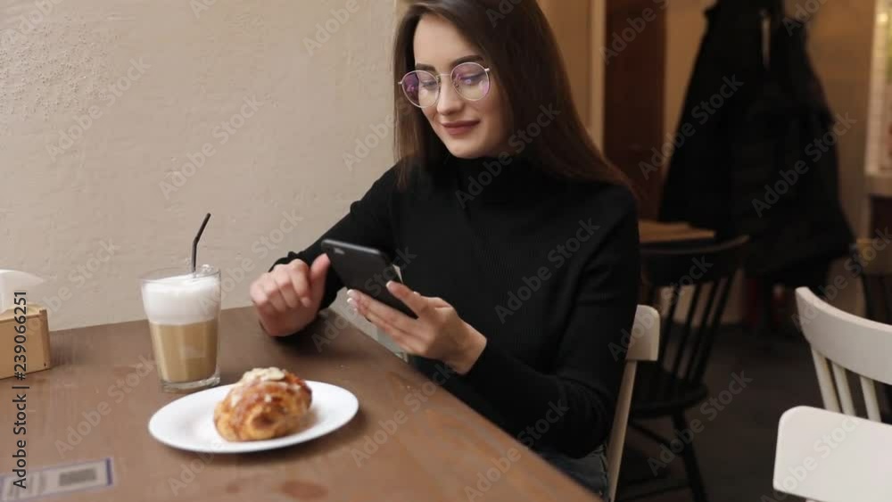 Young curly European woman looking at mobile phone Young curly European woman looking at mobile phone