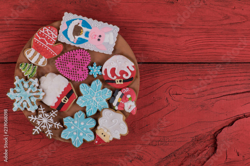 Christmas gingerbread cookies on a red wooden rustic table