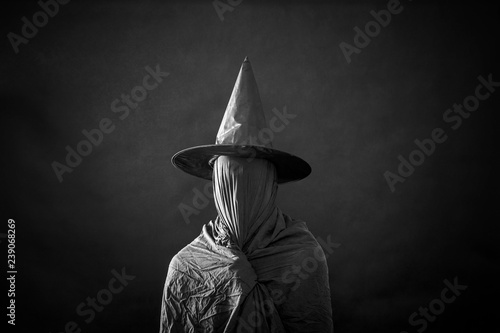 Photography Ghostly figure with long hat in the dark