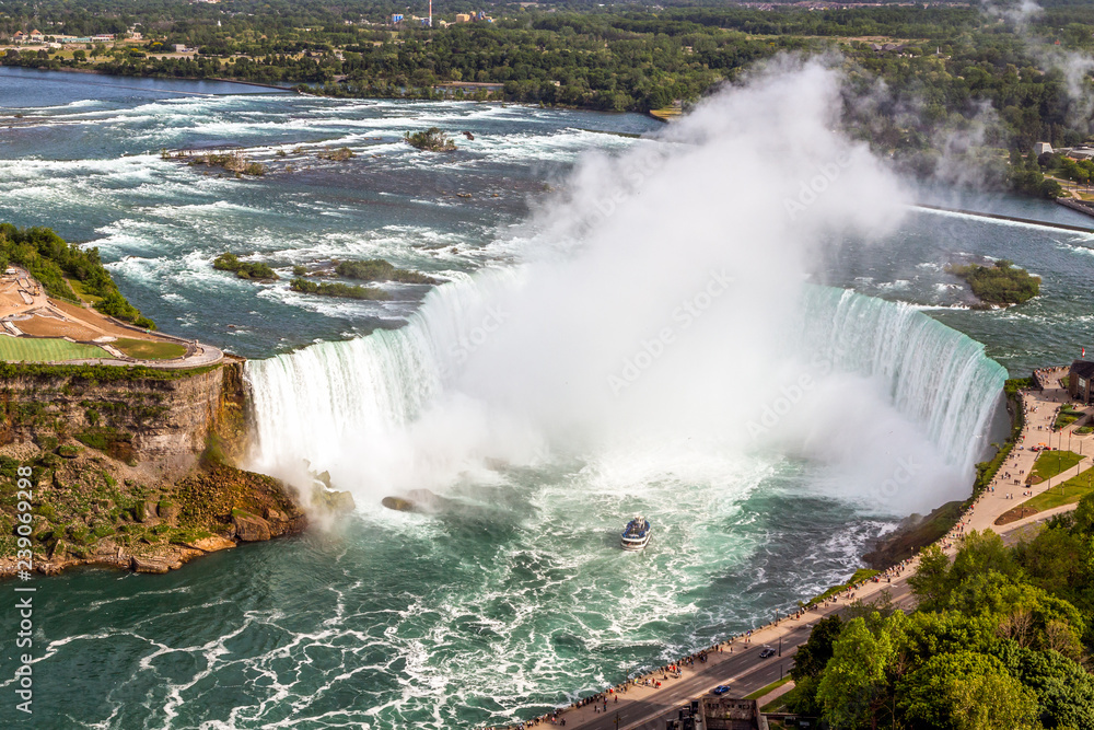 Breathtaking aerial view of Niagara Horseshoe Falls, the Canadian side of Niagara Falls, also boats and upper Niagara river. Breathtaking aerial view of Niagara Horseshoe Falls, the Canadian side of Niagara Falls, also boats and upper Niagara river.