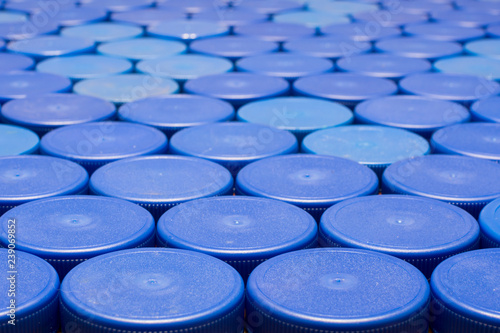 a lot of blue plastic bottle caps, close-up. Concept: waste disposal, environmental protection.