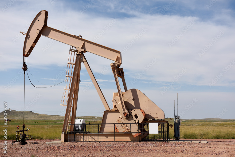 Crude oil production well site pump jack in the Niobrara shale of Wyoming. Crude oil production well site pump jack in the Niobrara shale of Wyoming.