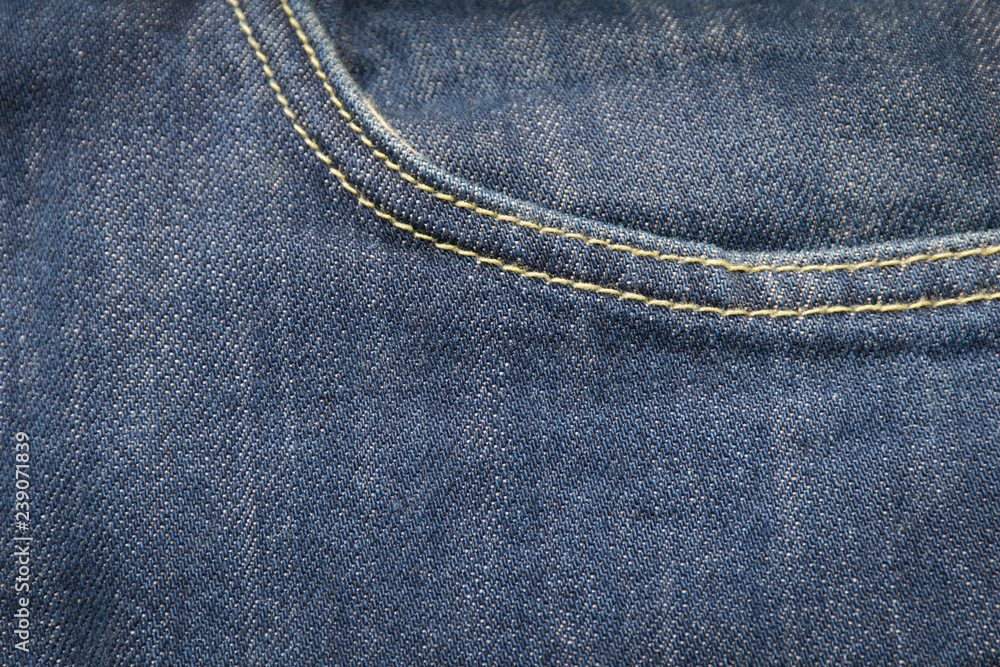 closeup front pocket on blue denim jeans and button closeup front pocket on blue denim jeans and button