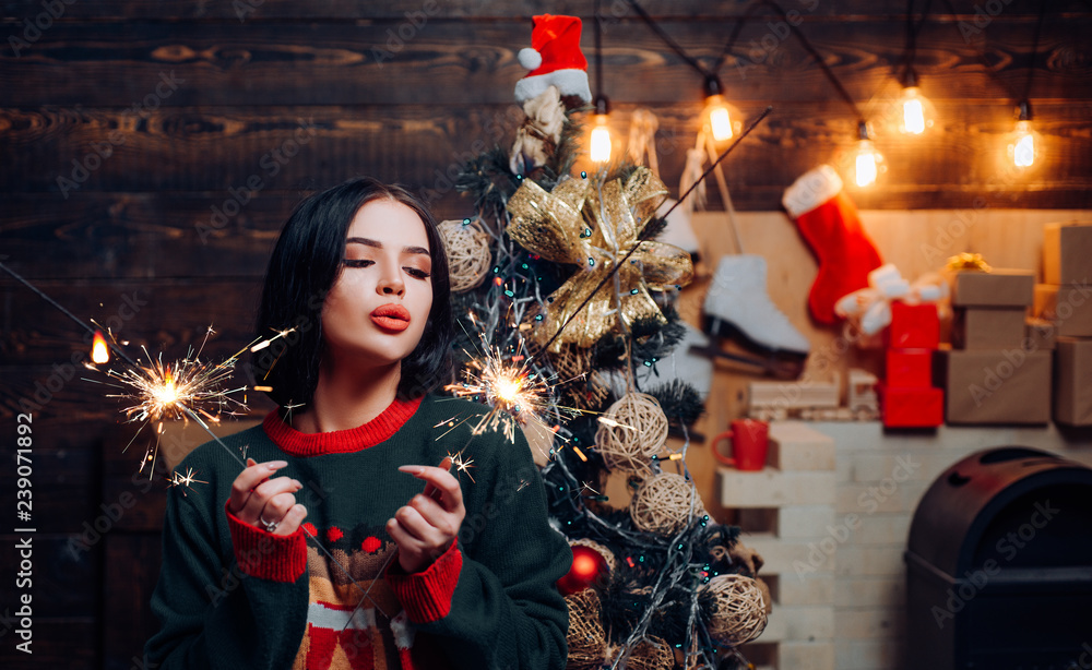 Excited woman in red santa claus outfit holding present. Woman new