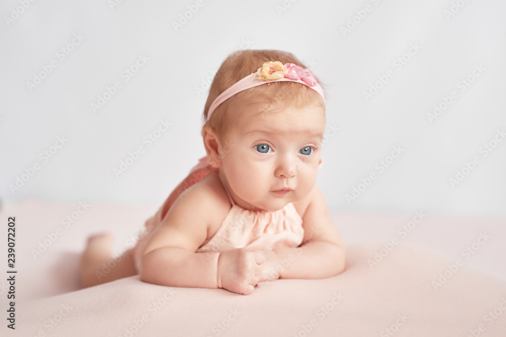 Cute newborn baby girl, three months old, lies in blanket. Baby goods packaging template. Closeup portrait of newborn baby with smile on face. Healthy and medical concept. Eco conception.