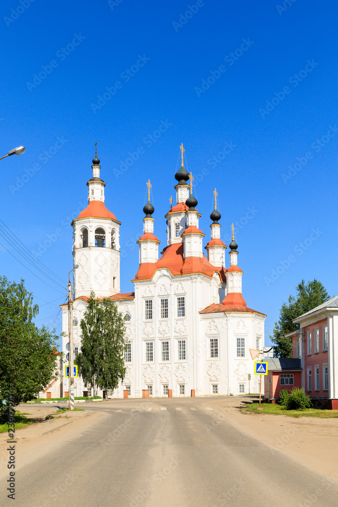 Russian white orthodox Temple of the Entry of the Lord into Jerusalem against the blue sky The Nativity Church, Totma, Russia. Architectural forms reminiscent of a ship.