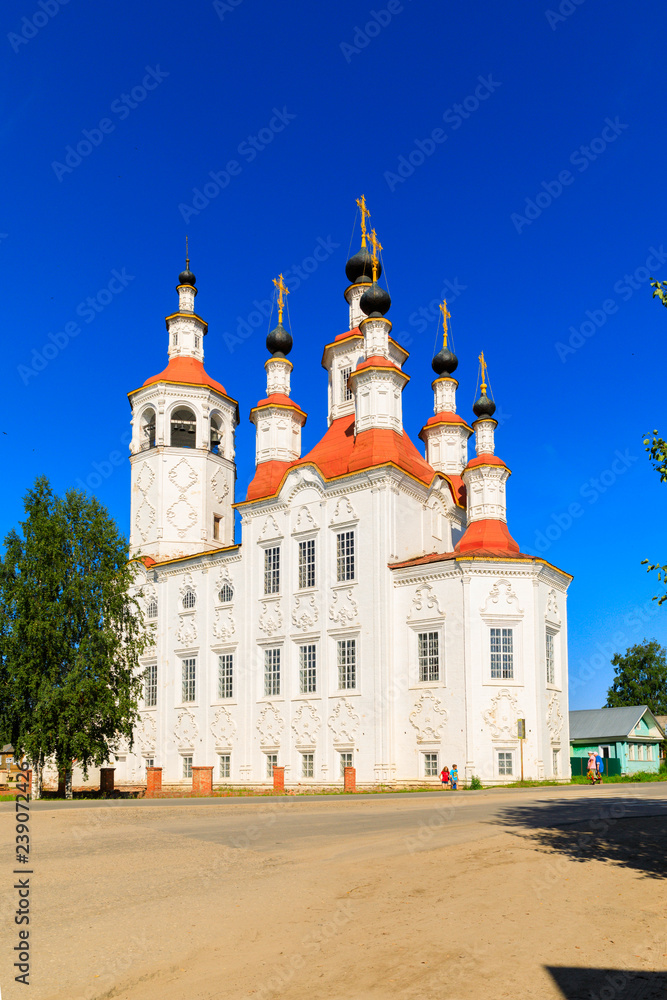 Russian white orthodox Temple of the Entry of the Lord into Jerusalem against the blue sky The Nativity Church, Totma, Russia. Architectural forms reminiscent of a ship.