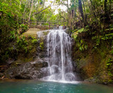 A hiking trail near a waterfall in Colo-i-Suva rain forest national park, nature reserve near Suva, Viti Levu island, Fiji, Melanesia, Oceania.