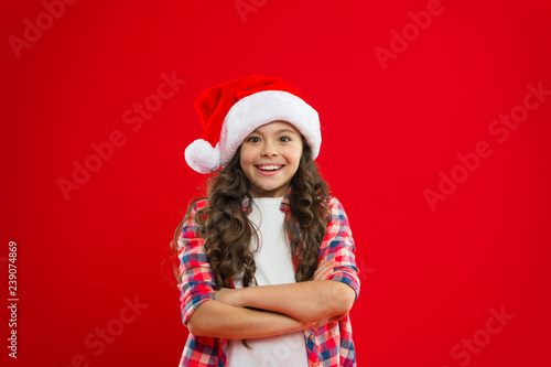 Christmas shopping. New year party. Santa claus kid. Happy winter holidays. Small girl. Present for Xmas. Childhood. Little girl child in santa red hat. Watching Christmas shows together