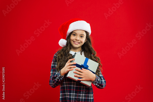 Little girl child in santa red hat. Christmas shopping. New year party. Santa claus kid. Present for Xmas. Childhood. Happy winter holidays. Small girl. gift delivery © be free