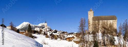 Savognin, Snowy and sunlit tourist village photo