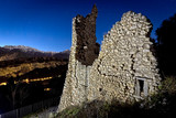 Medioval ruins of the Penede Castle of Nago. In the background the Mount Brione (Trentino, Italy)