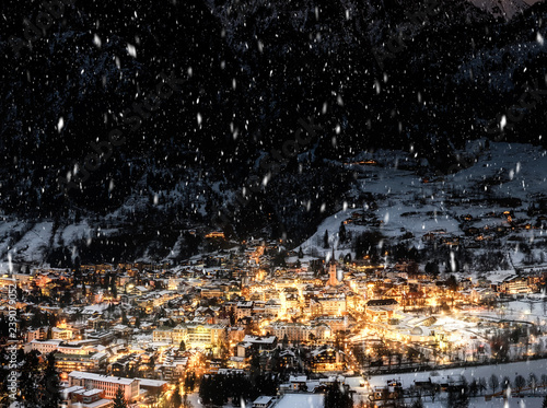 Night view of village in mountains during snowfall in the night photo