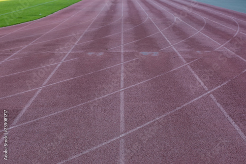 Fototapeta Naklejka Na Ścianę i Meble -  running dirty old track marking road background material texture in football stadium perspective foreshortening, copy space 