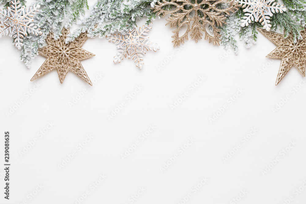 Obraz premium Christmas white Fir tree branches with gold stars decorations.