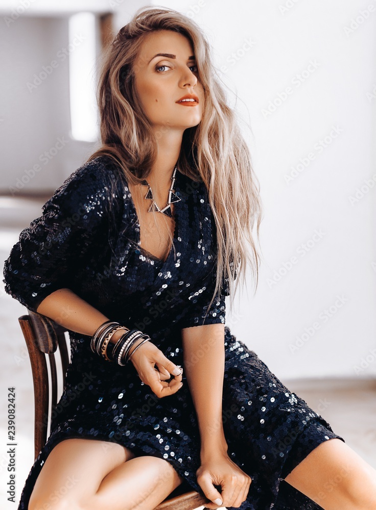 Portrait of beautiful young blonde woman with makeup  in black fashion clothes