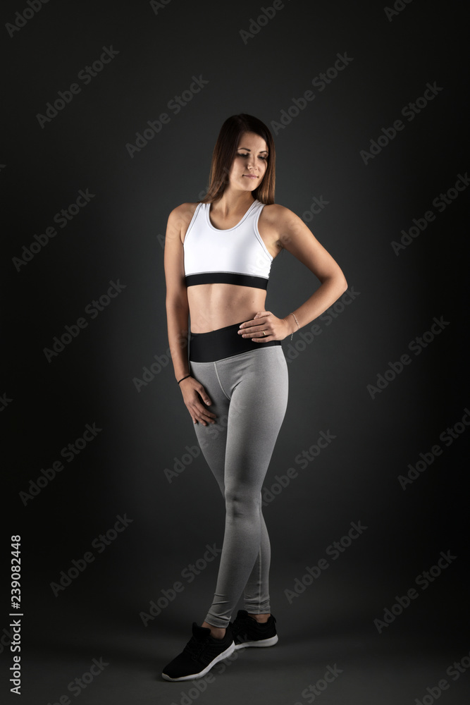 Happy young woman in sports clothing smiling Happy young woman in sports clothing smiling