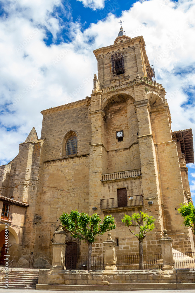 Church of Santa Maria in Viana, Navarre Spain against a beautiful blue May sky with fluffy white clouds