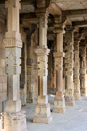Columns with stone carving in courtyard of Quwwat Ul Islam mosque, Qutub Minaret complex, Delhi, India
