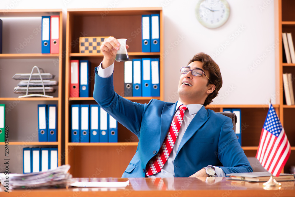 Young handsome politician sitting in office Young handsome politician sitting in office