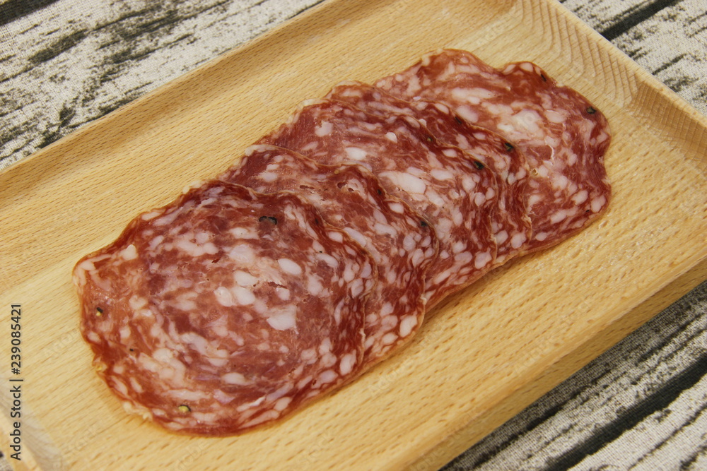 Saucisson en tranches sur une planche en bois Saucisson en tranches sur une planche en bois