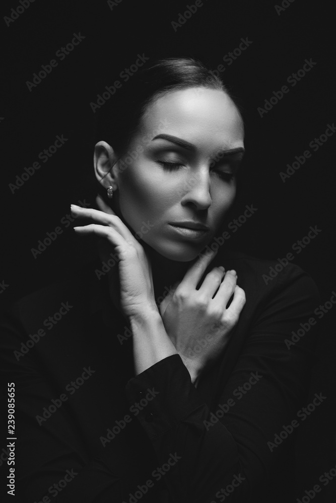 Obraz premium Black and white portrait of attractive brunette sexy girl. Beautiful girl posing. Young woman on black background. Studio shot