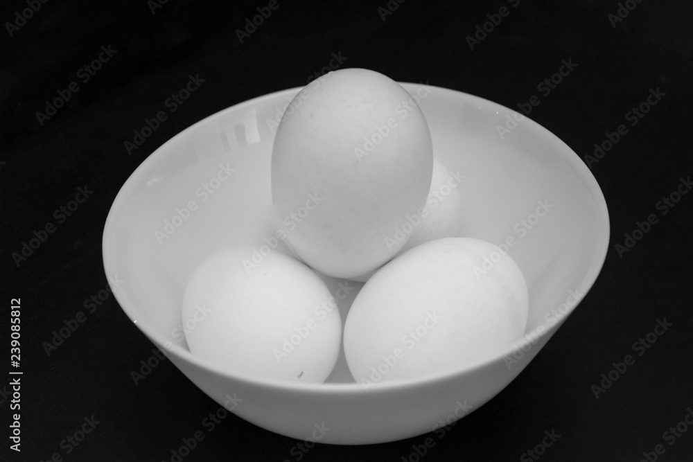 White bowl containing white chicken eggs White bowl containing white chicken eggs