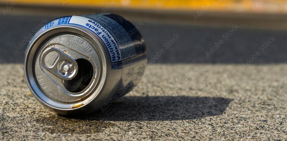 Close up of an empty can of coke, lien down on pavement. Close up of an empty can of coke, lien down on pavement.