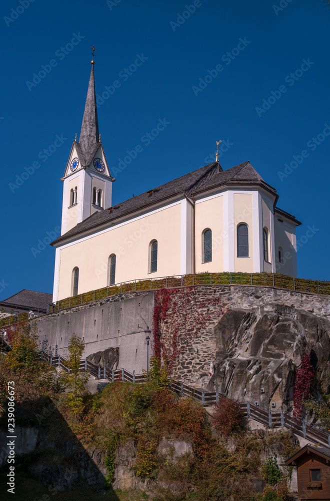 Kaprun, Austria. Catholic church St. Margaretha. Church on the mountain. Steep stairs lead to the church
