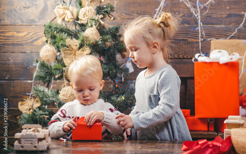 New year kids. Portrait kid with gift on wooden background. Funny kid holding Christmas gift. Merry Christmas. Christmas children. Funny kid holding Christmas gift.