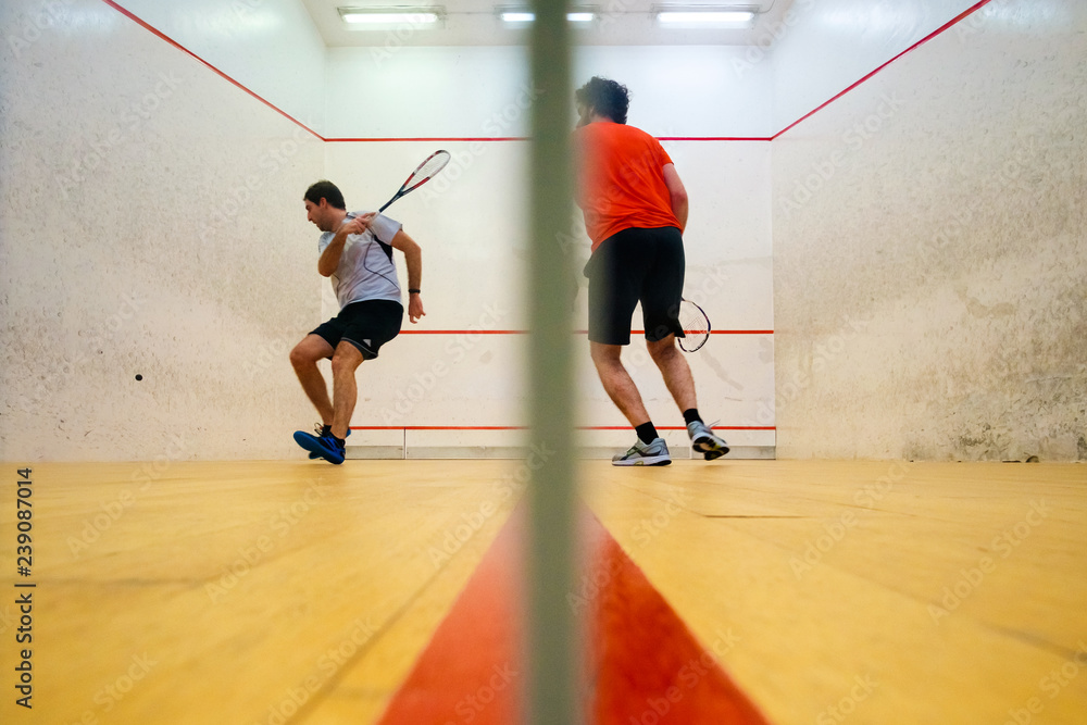 Two friends playing squash in Mutilva, Navarra, Spain