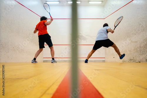 Two friends playing squash in Mutilva, Navarra, Spain © mikelju