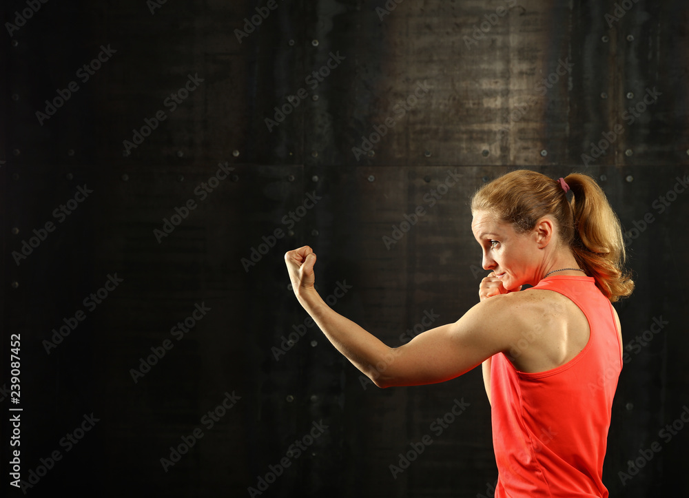 Side profile view of young athletic women boxing