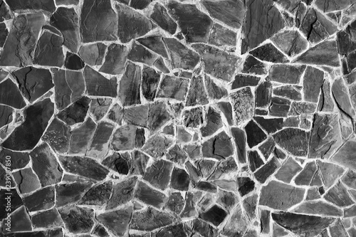 Fotografi Black and white stone texture. Wall of stone. Stone-paved road.