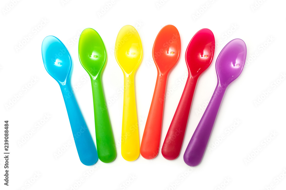set of colorful baby plastic spoons on white background set of colorful baby plastic spoons on white background