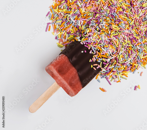 Popsicle dipped in chocolate and sprinkles  photo