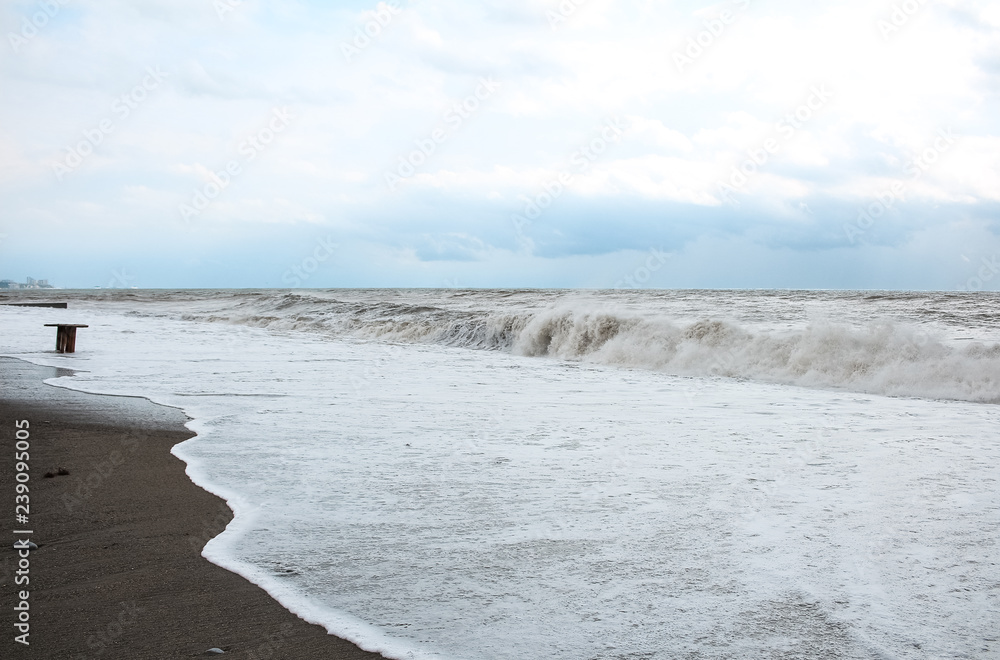 Sea coast during a storm, white foam and waves Sea coast during a storm, white foam and waves