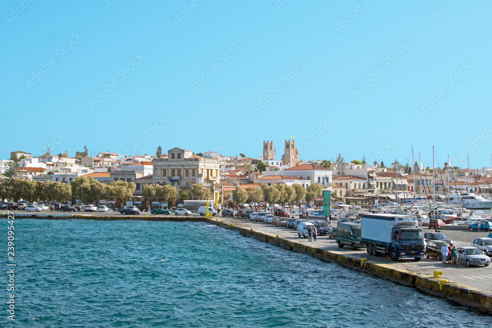 The port of the island of Aegina in the Mediterranean, view from the board of a suitable ship. Waiting for mooring cars and people on the pier