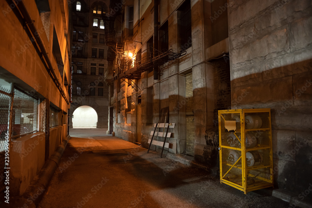 Dark and eerie downtown urban city alley at night