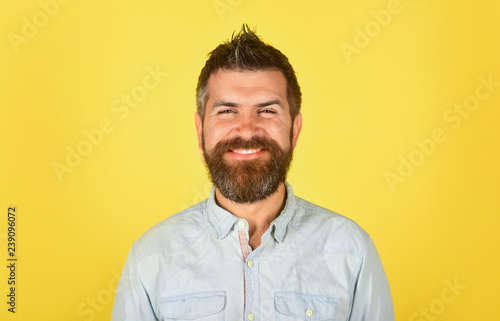 Fashionable bearded male portrait. Hipster in white shirt. Cheerful man with long beard and mustache. Barber fashion and beauty. Happy bearded man in casual clothes. Fashion model with stylish hair. © Svitlana