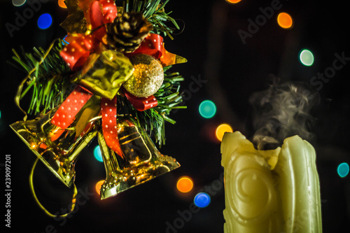 Christmas candles. The smoke from the extinguished fire candles on the background of Christmas tree branches. Happy New Year