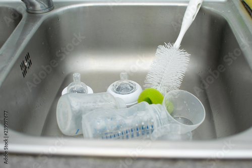 Baby bottle and the cleaner in the sink