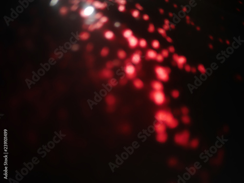 abstract lens flare on background. Red defocused bokeh lights. blur christmas wallpaper decor. festive glowing circles design.
