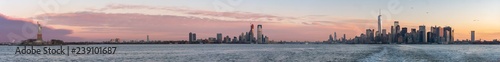 View of The Statue of Liberty, Downtown New Jersey and Downtown Manhattan During Early Cold Winter Morning © porqueno