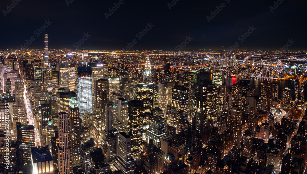 Fototapeta premium Night View of the Chrysler Buidling With the Queensborough Bridge in the Background
