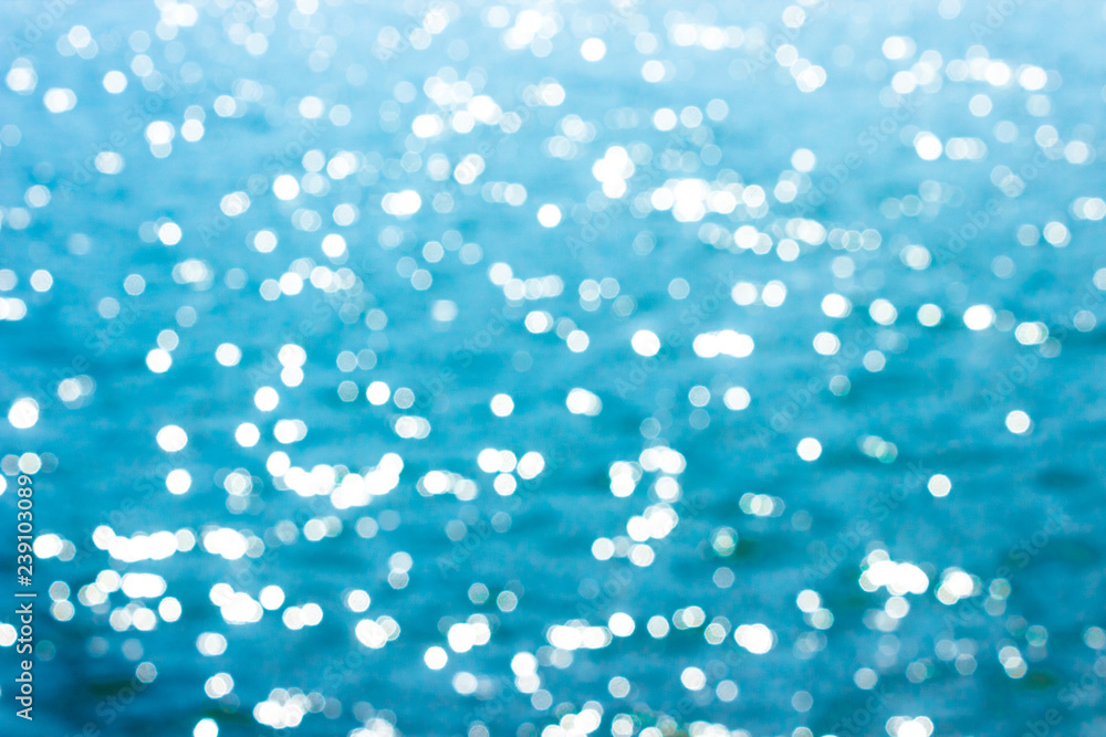Fototapeta premium Abstract bokeh sunlight background with summer blue sea.